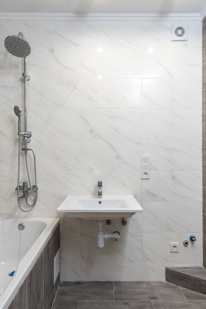 Elegant modern bathroom interior with wooden details and sleek design.